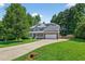 Charming two-story home featuring a brick and siding facade, solar panels, and a wide driveway at 1205 Magnolia Hill Rd, Garner, NC 27529