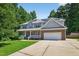 Inviting two-story home with a brick and siding exterior, solar panels, and attached two-car garage at 1205 Magnolia Hill Rd, Garner, NC 27529