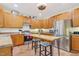 Bright kitchen featuring stainless steel appliances, a kitchen island with seating, and ample wood cabinetry at 1205 Magnolia Hill Rd, Garner, NC 27529
