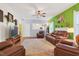 Inviting living room showcasing a fireplace, comfortable seating, hardwood floors, and access to the bathroom at 1205 Magnolia Hill Rd, Garner, NC 27529