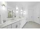 Bright bathroom with double vanities, marble countertops, and modern fixtures at 129 Damsire Way, Cary, NC 27513