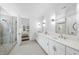 Bright bathroom with a glass enclosed shower, double vanities, and modern lighting at 129 Damsire Way, Cary, NC 27513