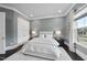 This is a bedroom with a queen bed, two white doors, a view to the outside and dark floors at 129 Damsire Way, Cary, NC 27513