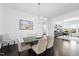 Bright dining room with modern chandelier, seating for six, and stylish decor at 129 Damsire Way, Cary, NC 27513