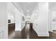 Inviting hallway with gleaming hardwood floors and crisp white trim and doors at 129 Damsire Way, Cary, NC 27513