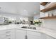 Bright kitchen with marble countertops, stainless steel sink, and open design to the living area at 129 Damsire Way, Cary, NC 27513