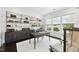 Bright home office features a wooden desk, large windows, and custom shelving at 129 Damsire Way, Cary, NC 27513