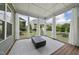Screened porch featuring white curtains, wood floors, and an outdoor coffee table at 129 Damsire Way, Cary, NC 27513