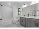 Bright bathroom with double vanity, shower with curtain, and modern fixtures at 1317 Fay St, Durham, NC 27701