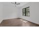 Bedroom features hardwood floors and natural light from a large window overlooking the front yard at 1317 Fay St, Durham, NC 27701