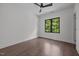 Empty bedroom featuring hardwood floors, neutral walls, and a large window for natural light at 1317 Fay St, Durham, NC 27701