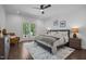 This bedroom features hardwood floors, a ceiling fan, and access to a private balcony at 1317 Fay St, Durham, NC 27701