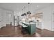Modern kitchen with a green island, stainless steel appliances, and open shelving at 1317 Fay St, Durham, NC 27701
