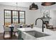 Beautiful island sink with stainless steel appliances and lighting fixture overlooking the dining area at 1317 Fay St, Durham, NC 27701