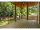 Spacious wooden patio with ceiling fan overlooks the backyard and lush greenery at 1317 Fay St, Durham, NC 27701