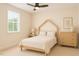 Cozy bedroom with minimalist decor, featuring a simple bed frame, and wooden dresser at 1344 Legend Oaks Dr, Chapel Hill, NC 27517