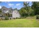 Side view of a charming home with well-maintained lawn and mature landscaping at 1344 Legend Oaks Dr, Chapel Hill, NC 27517