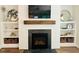 Living room fireplace with a wooden mantle and custom built-in shelves at 1344 Legend Oaks Dr, Chapel Hill, NC 27517