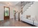 Welcoming foyer showcasing wood floors, stairs, and a seating area for guests at 1344 Legend Oaks Dr, Chapel Hill, NC 27517