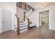 Elegant foyer featuring hardwood floors, a staircase, and a glimpse of the living space at 1344 Legend Oaks Dr, Chapel Hill, NC 27517