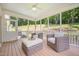 Screened porch with ceiling fan and comfortable seating, perfect for relaxing outdoors at 1344 Legend Oaks Dr, Chapel Hill, NC 27517