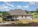 A lush backyard features a multi-tiered deck and screened porch for outdoor enjoyment at 1344 Legend Oaks Dr, Chapel Hill, NC 27517