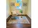Cozy sitting area with comfortable chair, stylish rug, and natural light at 1344 Legend Oaks Dr, Chapel Hill, NC 27517