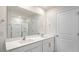 Modern bathroom featuring double sinks, a large mirror, and a glass-enclosed shower at 136 Pisgah St, Sanford, NC 27330