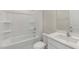 Bright bathroom with a bathtub, shower, and a white vanity with a quartz countertop at 136 Pisgah St, Sanford, NC 27330