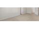 A bedroom with neutral carpet and trim, showcasing access to additional rooms at 136 Pisgah St, Sanford, NC 27330