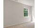 Carpeted bedroom with a large window and neutral paint at 136 Pisgah St, Sanford, NC 27330