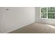 Bright carpeted bedroom featuring a window at 136 Pisgah St, Sanford, NC 27330