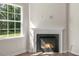 Close-up of the fireplace with a white mantel and large window at 136 Pisgah St, Sanford, NC 27330