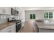 Bright kitchen with granite countertops, stainless steel appliances, and a view of the backyard at 136 Pisgah St, Sanford, NC 27330