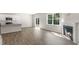 Open-concept living room with wood floors, a fireplace, and a breakfast bar, perfect for modern living at 136 Pisgah St, Sanford, NC 27330