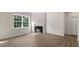 Living room featuring wood floors, a fireplace, and a large window at 136 Pisgah St, Sanford, NC 27330