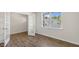 Open office space with hardwood floors, natural light, and glass-paneled door at 136 Pisgah St, Sanford, NC 27330