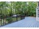 Spacious wooden back deck overlooking a lush backyard with mature trees and a storage shed at 140 Baron Cir, Youngsville, NC 27596