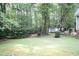 A large, grassy backyard with a storage shed sits at the edge of the tree line at 140 Baron Cir, Youngsville, NC 27596