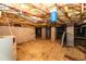 Unfinished basement with visible ceiling, plumbing, brick foundation, and concrete flooring at 140 Baron Cir, Youngsville, NC 27596