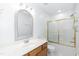 Bright bathroom featuring a shower and tub combo and a single sink vanity with an ornate mirror at 140 Baron Cir, Youngsville, NC 27596