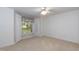 A bright, carpeted bedroom with a ceiling fan and a bay window with curtains at 140 Baron Cir, Youngsville, NC 27596