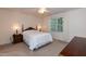 Cozy bedroom with soft lighting, neutral tones, and a comfortable bed, creating a peaceful retreat for relaxation and rest at 140 Baron Cir, Youngsville, NC 27596