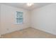 A bright, carpeted bedroom with a ceiling fan and a window at 140 Baron Cir, Youngsville, NC 27596