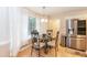 Bright breakfast nook featuring a round glass table and modern chairs with ample natural light from the sheer curtains at 140 Baron Cir, Youngsville, NC 27596