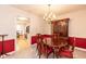 Traditional dining room with wood table, chandelier, and china cabinet, showcasing an adjacent space for added openness at 140 Baron Cir, Youngsville, NC 27596