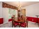 Traditional dining room with a round wood table, complemented by a decorative chandelier and a large window for ample natural light at 140 Baron Cir, Youngsville, NC 27596