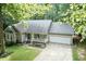 Charming single-story home with a two-car garage, well-manicured lawn, and inviting front porch at 140 Baron Cir, Youngsville, NC 27596