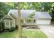 Attractive single-story home featuring an attached garage, covered front porch, and lush green lawn at 140 Baron Cir, Youngsville, NC 27596