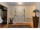 A home's front foyer featuring hardwood floors, a front door with sidelights, and traditional decor at 140 Baron Cir, Youngsville, NC 27596